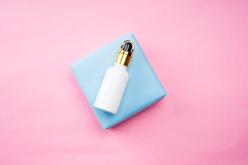 Cosmetic products arranged creatively on pastel colored background, flat lay view.