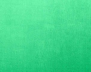 fragment of green cement wall with irregularities