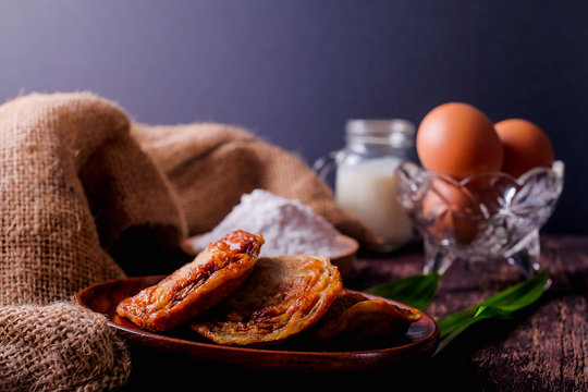 Akok Kedut, egg, coconut, flour , coconut milk and  Pandan leaf on wooden background. Akok Kedut is a traditional dish in Malaysia especially East Coast.