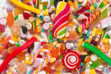 Colorful candies on wooden background