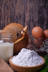 Akok Kedut, egg, coconut, flour , coconut milk and  Pandan leaf on wooden background. Akok Kedut is a traditional dish in Malaysia especially East Coast.