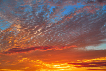 Sunset sky with orange clouds over blue
