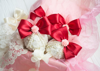 winter holiday decoration. Handmade Christmas ball decorated with a satin red ribbon, plastic flowers, pearls, lace.