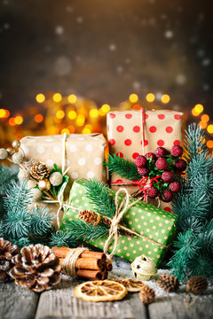 Merry Christmas and happy New year. Christmas gift and Christmas tree on dark wooden background. Selective focus.