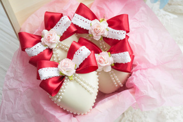 winter holiday decoration. Handmade Christmas tree toy decorated with a satin red ribbon, plastic flowers, pearls, lace.