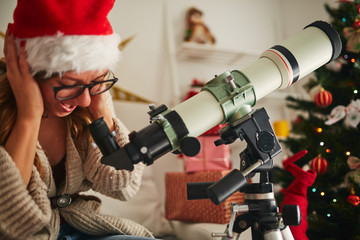 Christmas / New Year's joy with astronomy telescope and cujte girl.