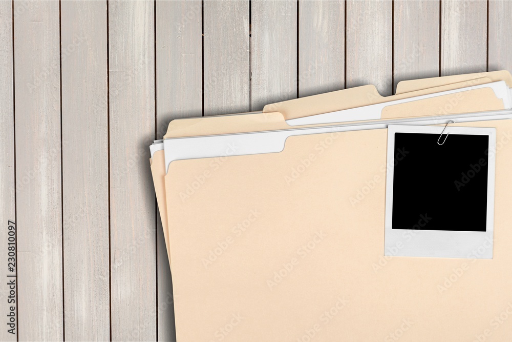 Wall mural Blank photo on business folder on wooden table