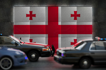 Bright digital display Georgia flag in city as cars drive past