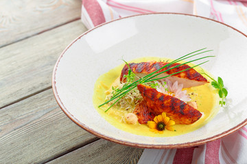 Marinated grilled healthy chicken breasts cooked on a summer BBQ and served with fresh herbs