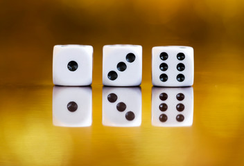 Fototapeta na wymiar Casino, success concept - reflected dices on golden background with copy space