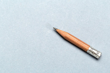 Still life of short worn down  pencil on light gray background