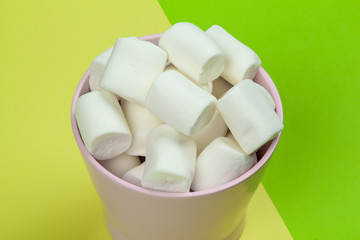 sweet marshmallow, candy on green background, top view