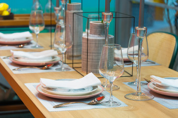 Luxury dining table settings for dining and glassware, candle, modern ceramic vase with tree plant interior decoration