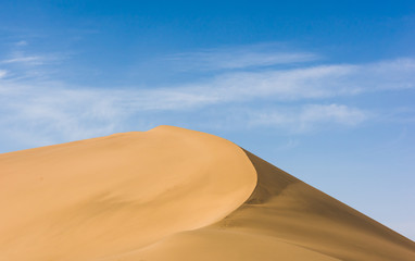 Fototapeta na wymiar Desert sand dunes with blue sky background