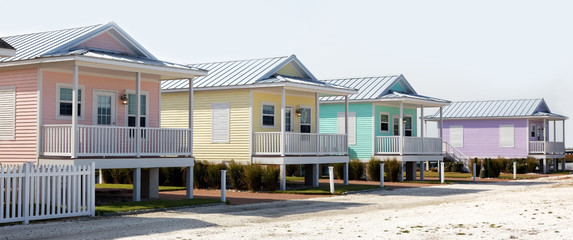 Colorful pastel summer rental cottages. - obrazy, fototapety, plakaty