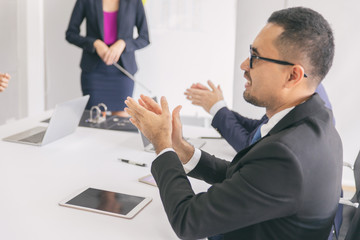 A business meeting and Asian man clapping office.