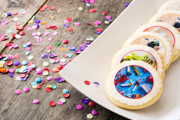New Year cookies and confetti on white background. Copyspace