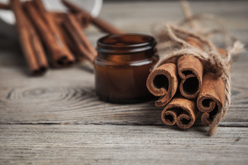 Cinnamon sticks on wooden background.