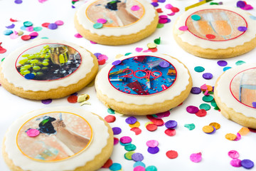 New Year cookies and confetti on white background