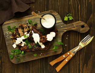 Grilled beef liver with white sauce. View from above.