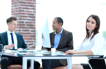 Executive business woman in office on the background of business team