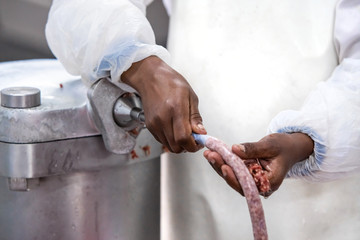 Sausage being made in butchery.