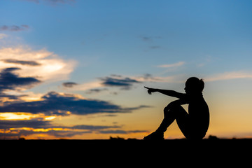 silhouette of woman Looking for a dream at sunset