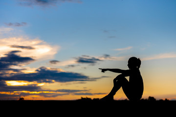 silhouette of woman Looking for a dream at sunset