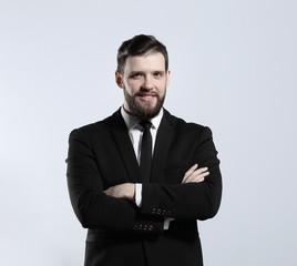 in full growth.portrait of a successful businessman.isolated on grey background