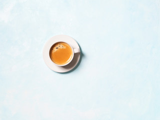 One cup of coffee espresso on a blue pastel background with space for text. Flat lay.