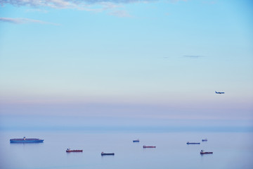 the plane flies over the ships into the sea