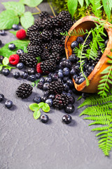 Freshly assorted berries in wooden bowl. Juicy and fresh blueberries6 blackberries and raspberries...