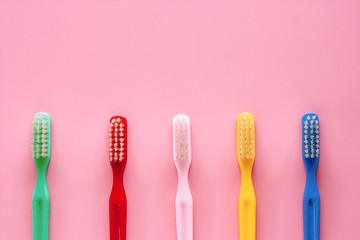 Toothbrush used for cleaning the teeth on pink background for dental care concept