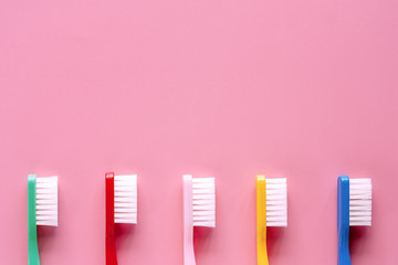 Toothbrush used for cleaning the teeth on pink background for dental care concept