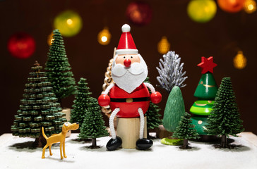 Santa Claus sit on circle wooden chair with dog watching among Christmas tree