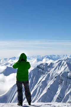 Skier on top of snowy mountains