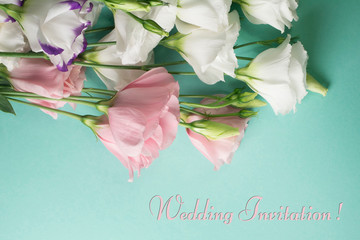 Wedding invitation card. White eustoma flowers on a light turquoise background