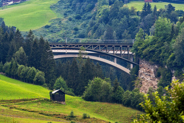 A picturesque Alpine landscape with an old railway bridge. Austria.