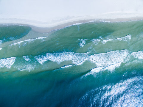 Drone/Aerial Photograph of the Gulf of Mexico washing ashore on the beautiful white sand beach of Gulf Shores/Fort Morgan, Alabama.  USA