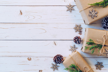 Homemade wrapped christmas gift box presents on a wood table background.