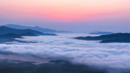 Beautiful view above the clouds on the mountains from the aerial view