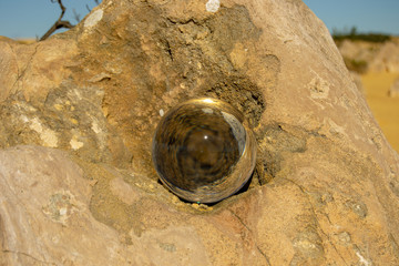 Glass sphere over the pinacles landscape