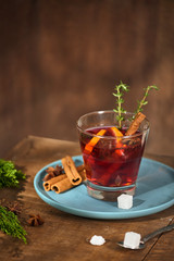 Cold ginger tea with orange and lemon in glass cups. Tea with sugar. The decor. Cinnamon and Rosemary Spices