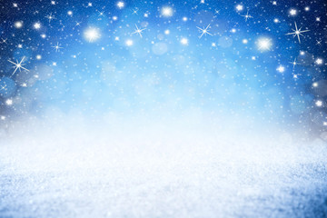 christmas xmas blue snow bokeh background with many shiny stars lights with copy space /...