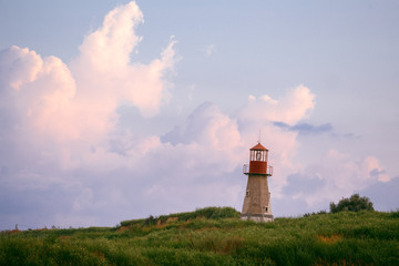 Fototapeta na wymiar lighthouse at sunset with beautiful clouds