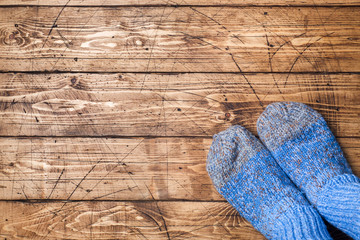 Legs in woolly knitted socks on wooden background. Copy space