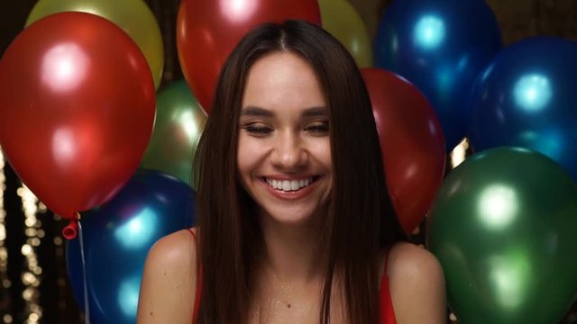 Birthday Party. Smiling Woman Blowing Glitter Near Balloons 