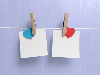 Blank paper notes cards with hearts and clothespins hanging on a rope. 3d illustration