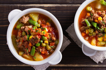 Delicious hamburger soup with vegetables. View from above, top studio shot