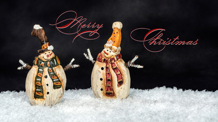 Merry Christmas: Pair of two smiling traditional vintage snowmen puppets in festive Christmas...
